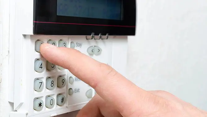 A person is touching the screen on an alarm.