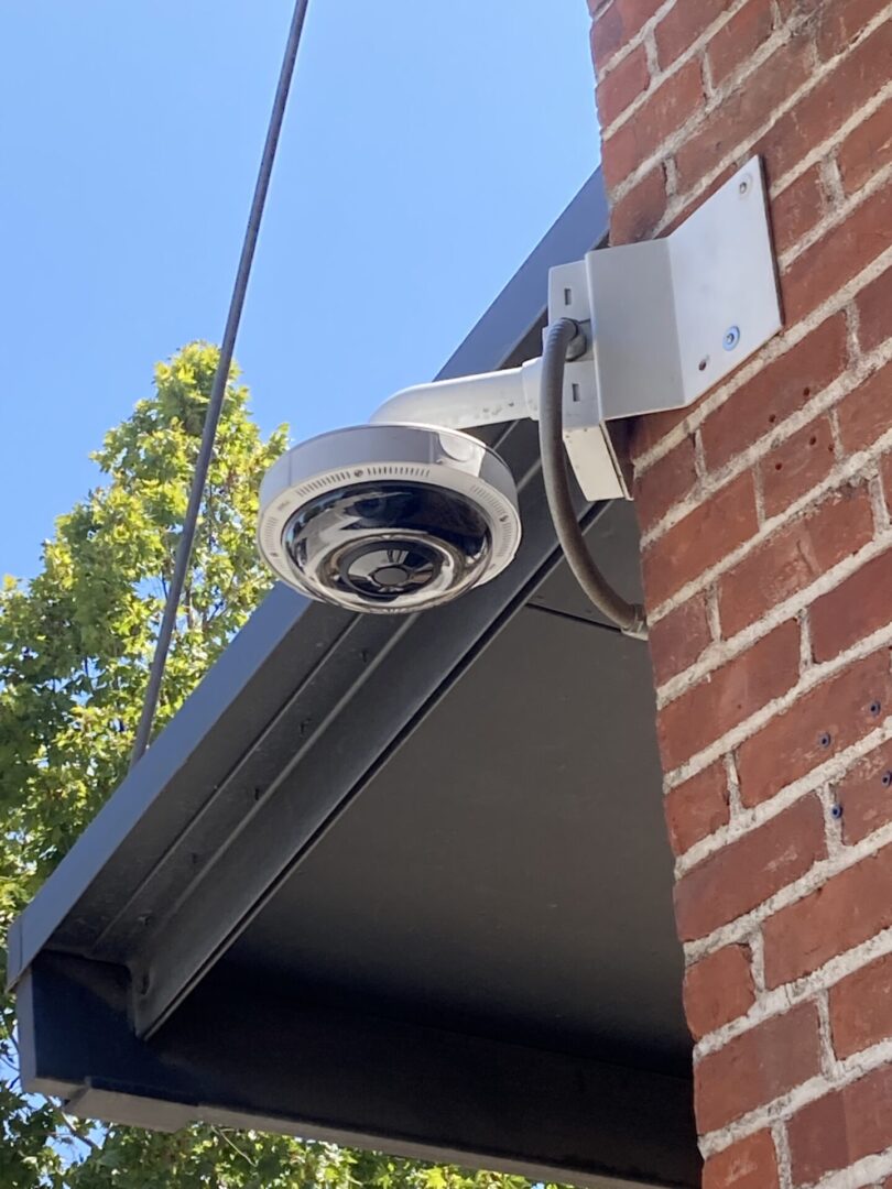 A security camera mounted on the side of a building.