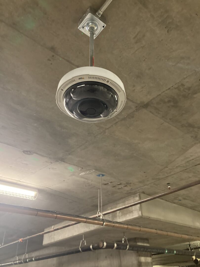 A ceiling mounted speaker in the middle of a room.